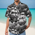 Man wearing a pirate ship themed  hawaiian shirt with jeans on a beach in the Caribbean Sea
