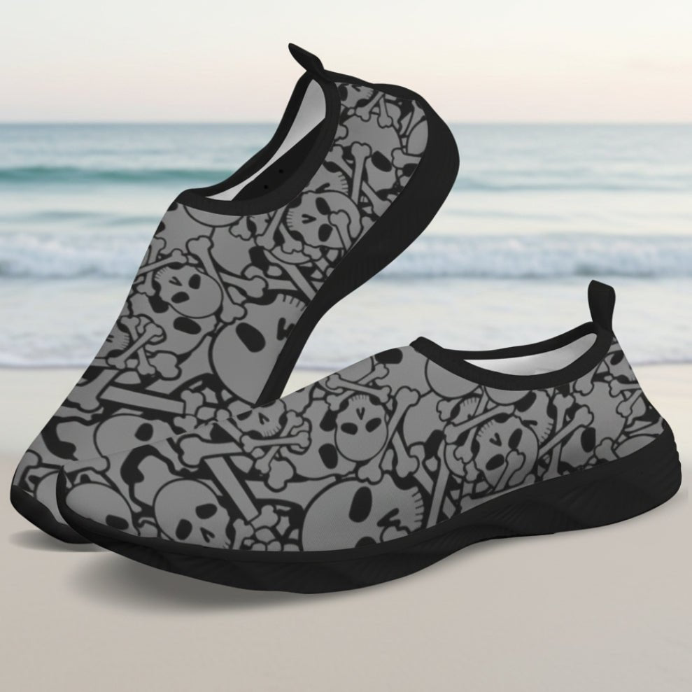 A pair of slip-on water shoes featuring a gray and black skull and crossbones pattern, displayed against a clean white background.