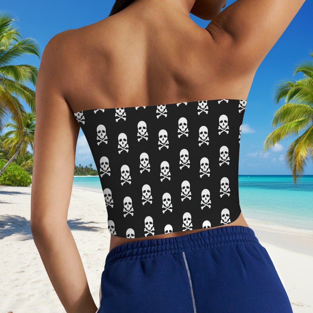 Bikini Model wearing a black strapless top with white skull and crossbones pattern and blue shorts on a tropical Caribbean Island Beach