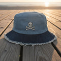Blue bucket hat with frayed edge on a  beachside boardwalk