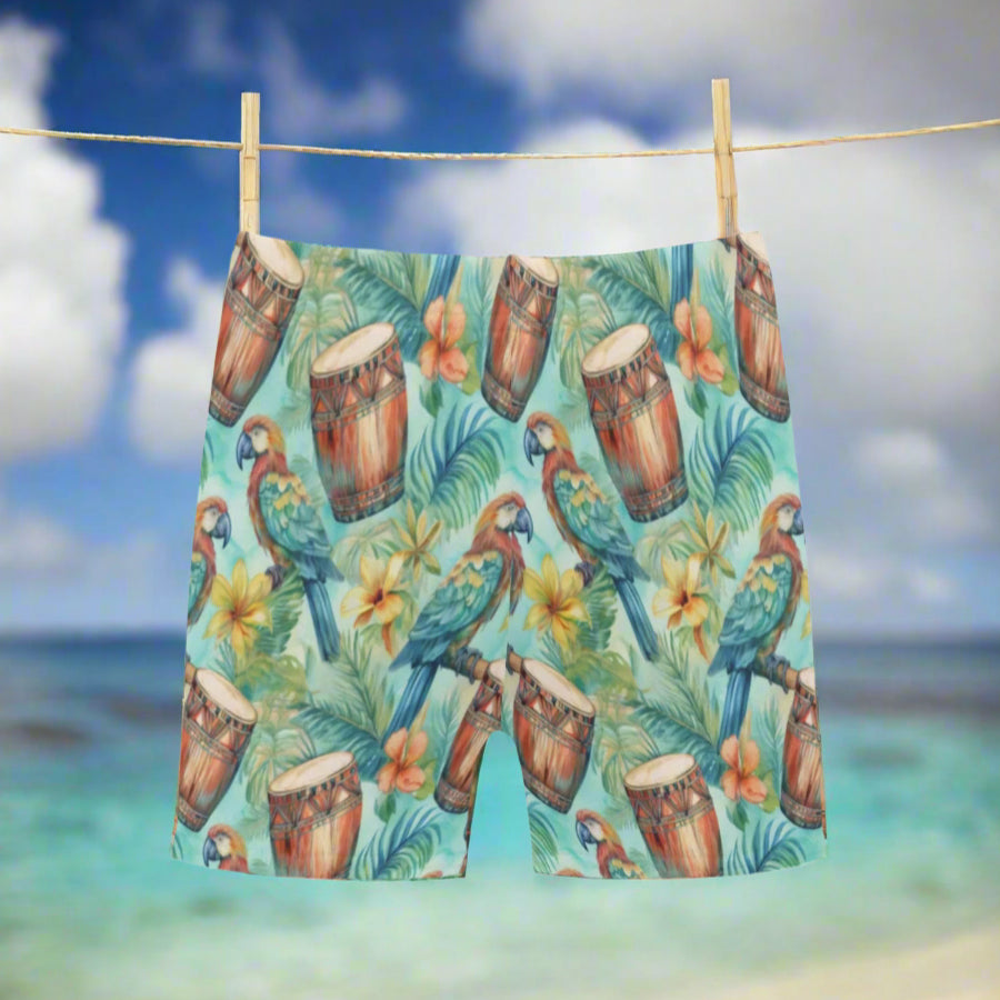 Shorts with a tropical pattern featuring parrots, drums, and flowers, hanging on a clothesline on beach in Hawaii