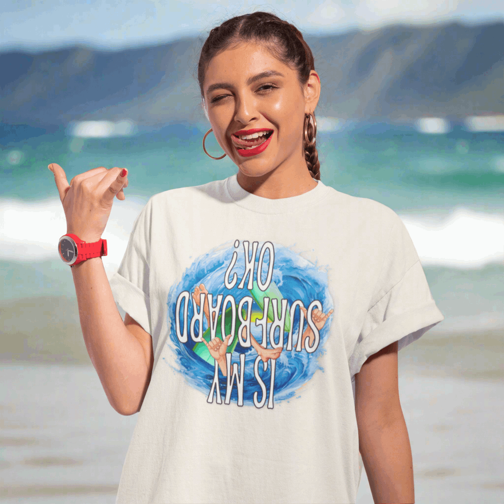 Surfer Girl wearing a funny t-shirt about surfing hanging loose on the beach at the north shore of O'ahu