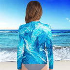 Girl wearing a long sleeve Rash Guard patterned long-sleeve shirt on a beach with ocean view