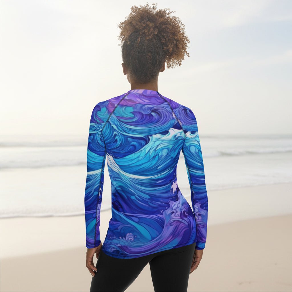 Person wearing a long-sleeve shirt with a blue and purple wave pattern on a faded beach background