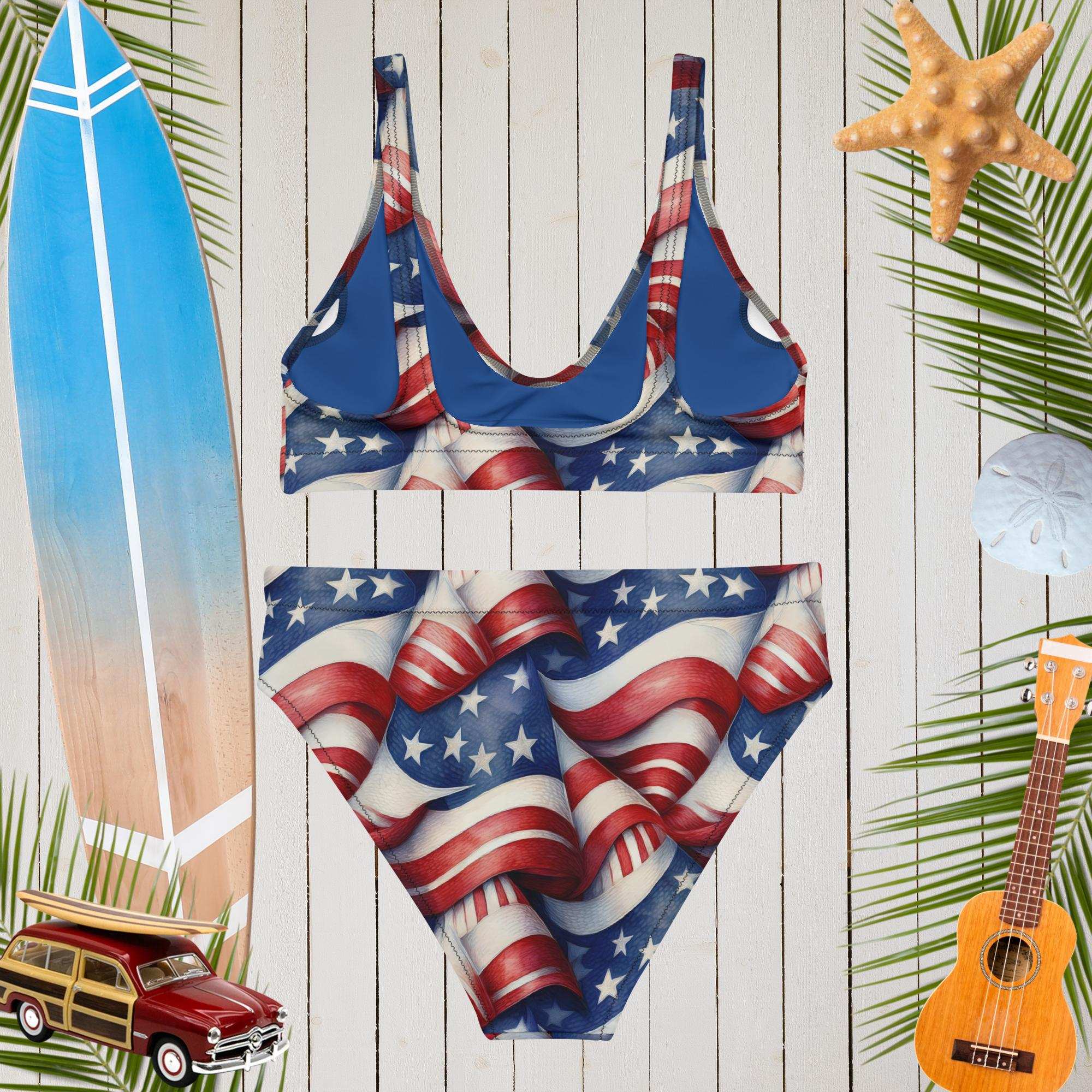 American flag swimsuit on a wooden background with beach accessories.