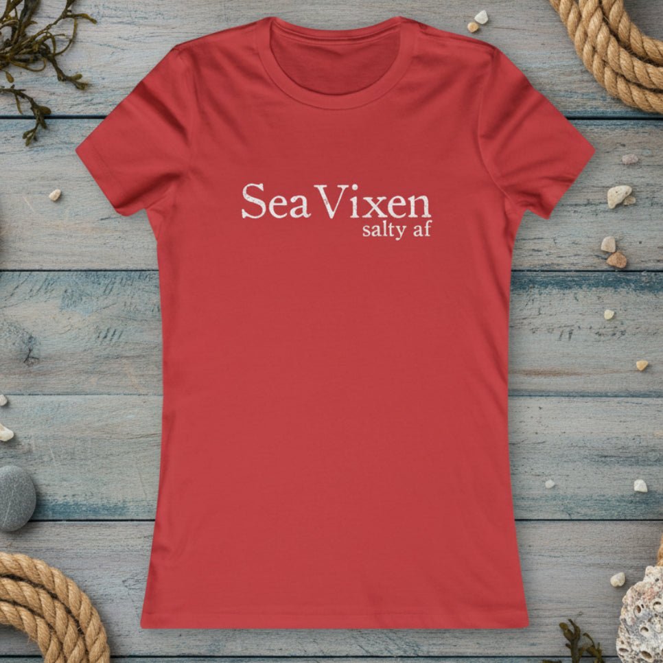 Red t-shirt with 'Sea Vixen salty af' text on a rustic nautical wood background