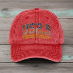 Red cap with '1776-2023' text and American flag design on a white background