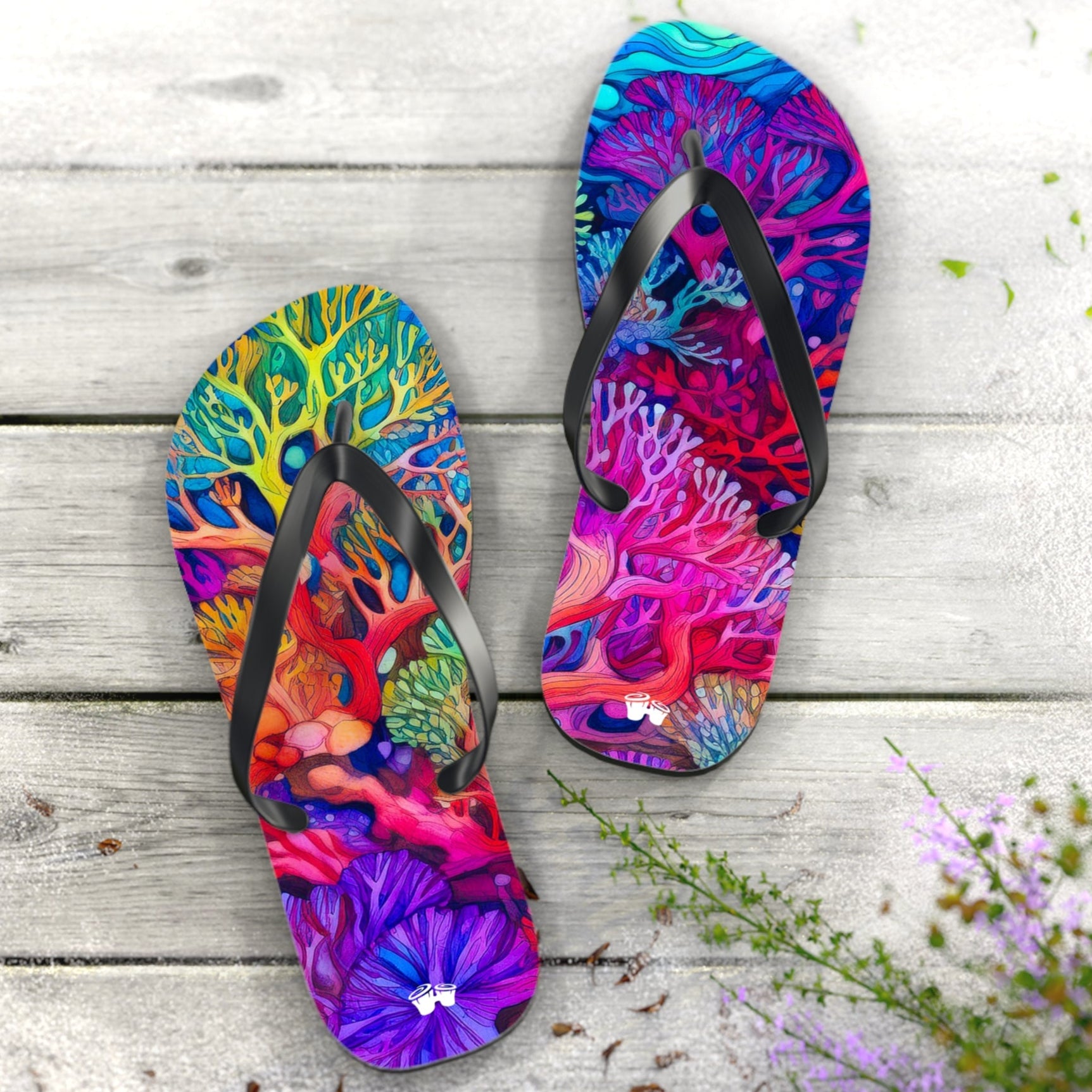 Colorful flip-flops with coral reef design on a wooden surface