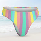 Multicolored striped bikini bottom on a faded beach background