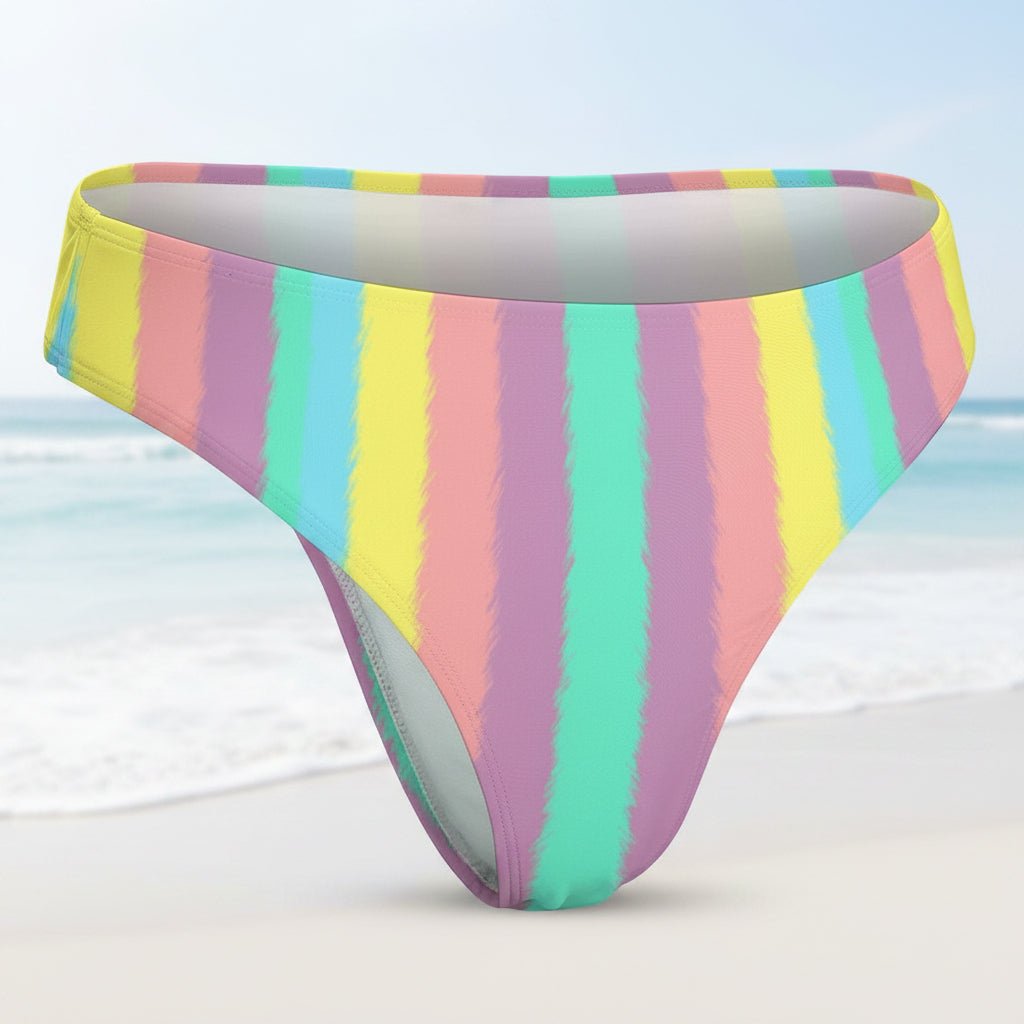 Multicolored striped bikini bottom on a faded beach background