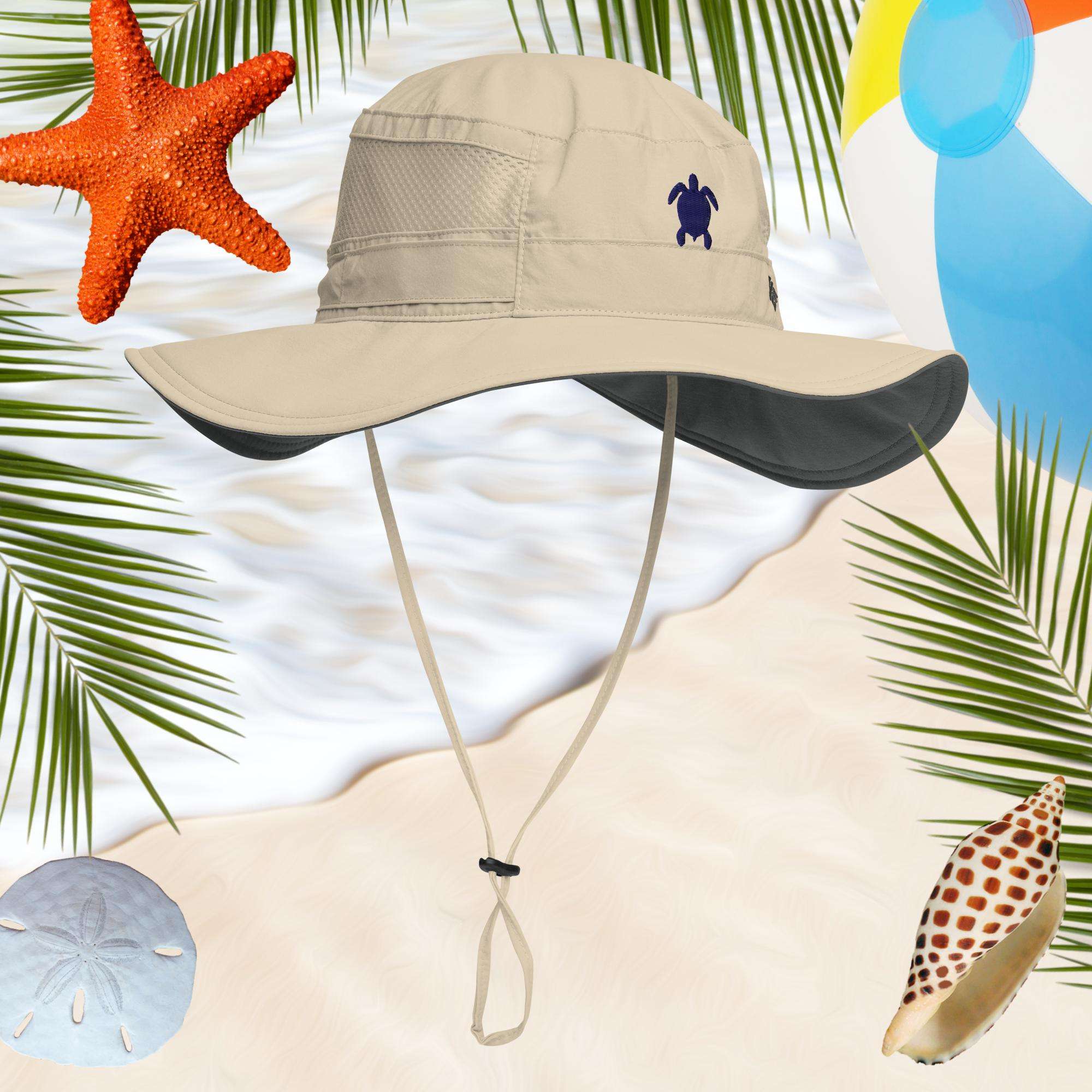 Beige bucket hat with a sea turtle embroidery on a beach-themed background with palm leaves, starfish, and shells.