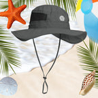 Gray wide-brimmed hat with a strap on a beach-themed background with palm leaves, starfish, and shells.