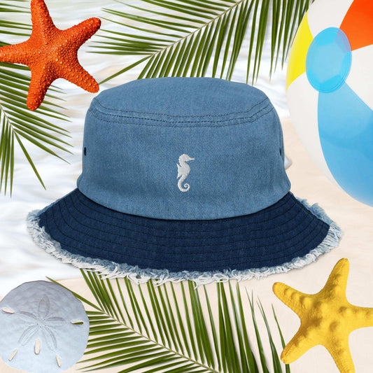 Sea Horse Jean Bucket Hat with embroidery, perfect for seaside style, surrounded by beach elements.