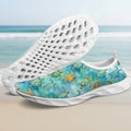 A pair of slip-on water shoes with a white sole and a blue-green watercolor sea turtle print on the upper, shown on a clean white background.
