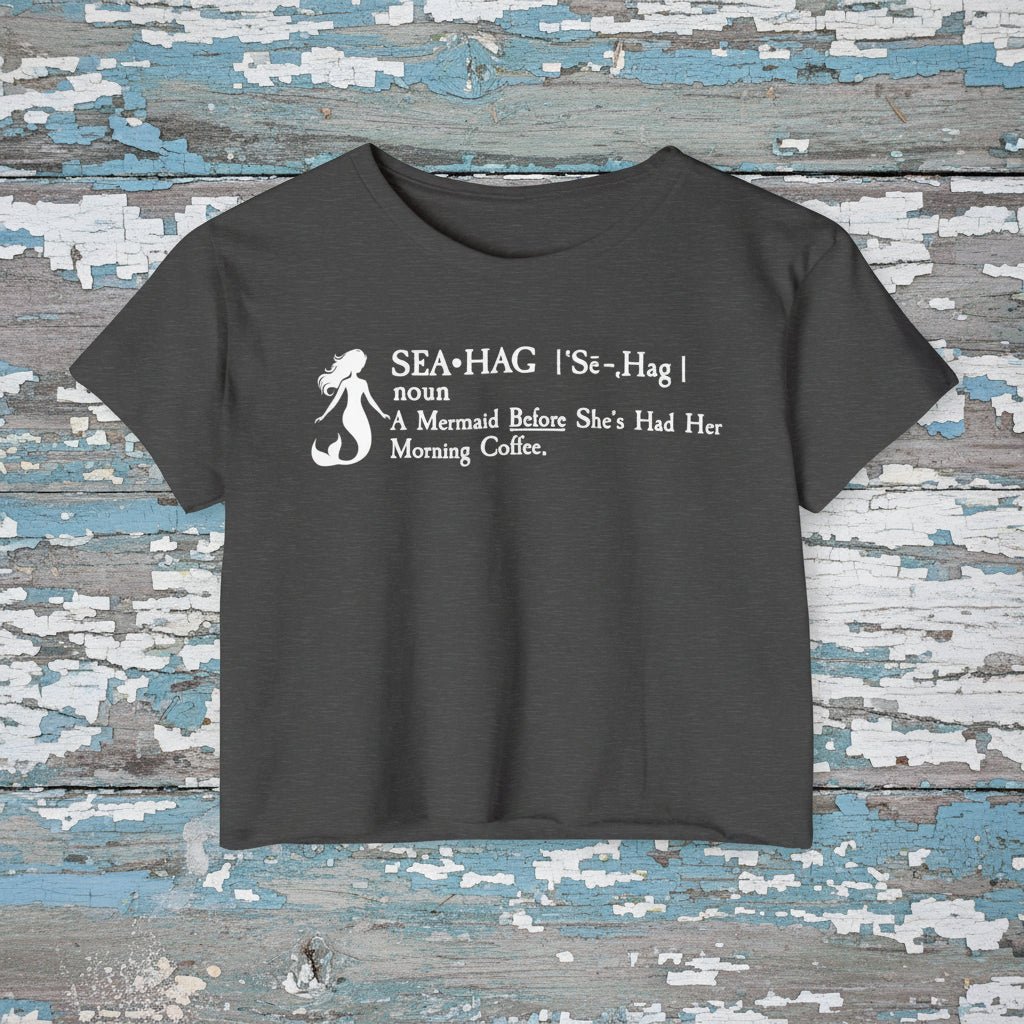 Navy blue t-shirt with white mermaid graphic and text on a rustic wood background