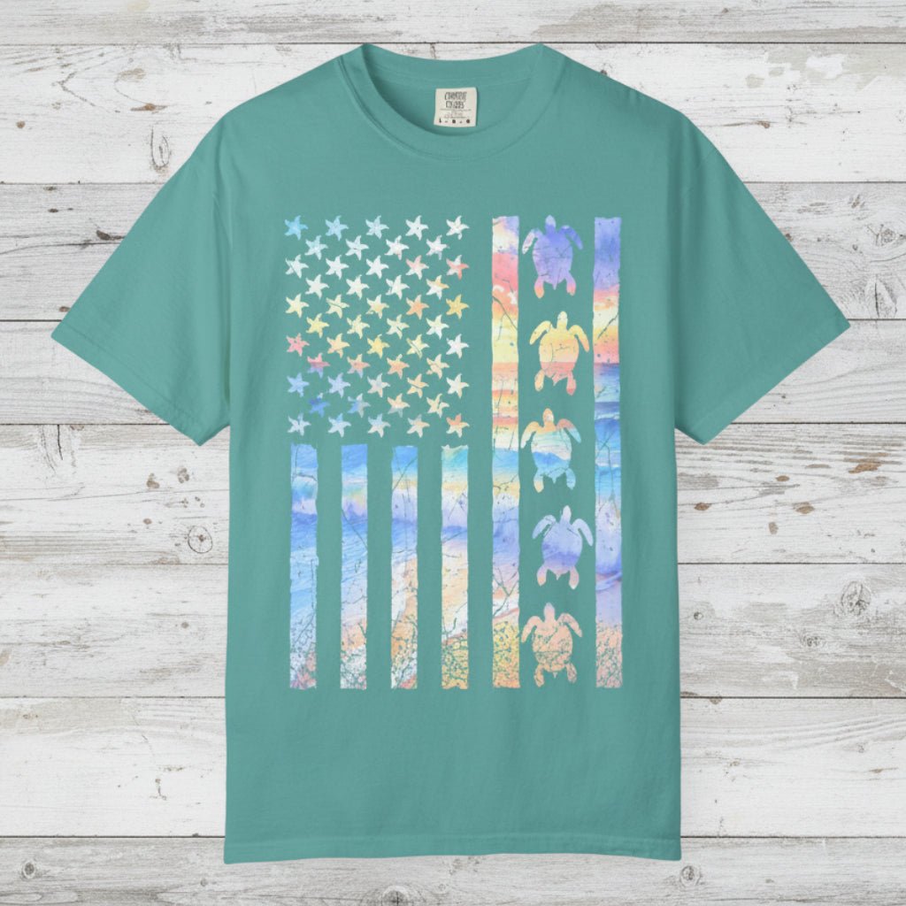 Teal t-shirt with a colorful American flag design featuring turtles on a nautical wood background