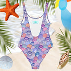 Back of Ladies one piece Seashell Pattern swimsuit over a beachy background