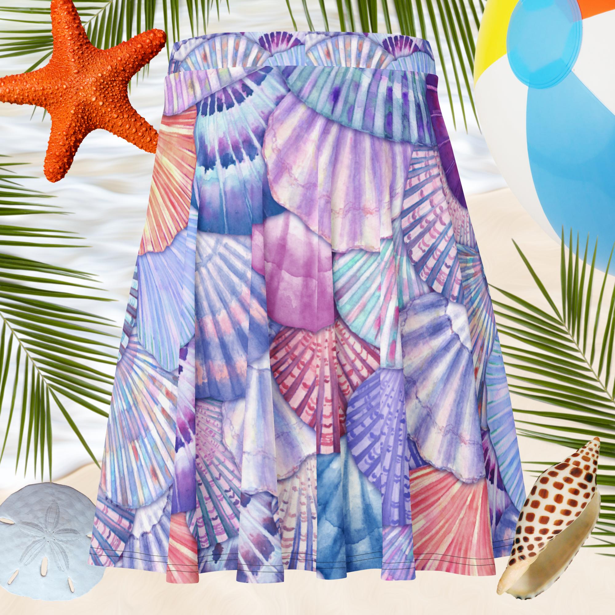 Colorful dress with shell pattern on a beach background with starfish, umbrella, and conch shell.