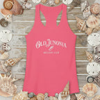 Pink tank top with 'Old Junonia Sheller's Club' text on a wooden surface surrounded by seashells.