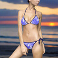 Pretty Model in Blue Tone Bikini with Hawaiian floral pattern standing on the beach
