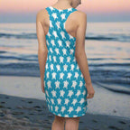 Swimwear model facing the ocean in a racerback tank-top-dress
