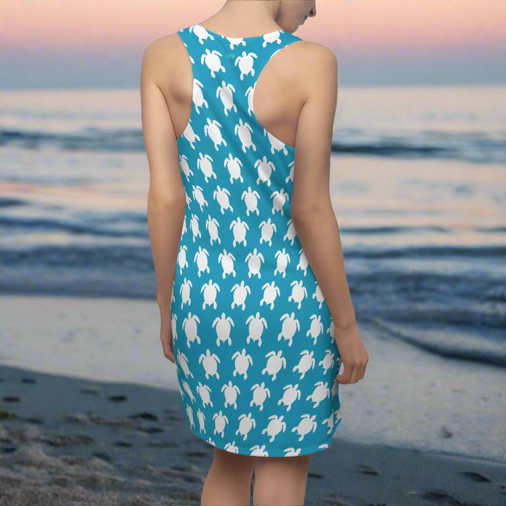 Swimwear model facing the ocean in a racerback tank-top-dress