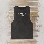A dark charcoal gray sleeveless tank top with a white skeleton shaka hand sign graphic on the chest, laid flat on a rustic wooden plank background.