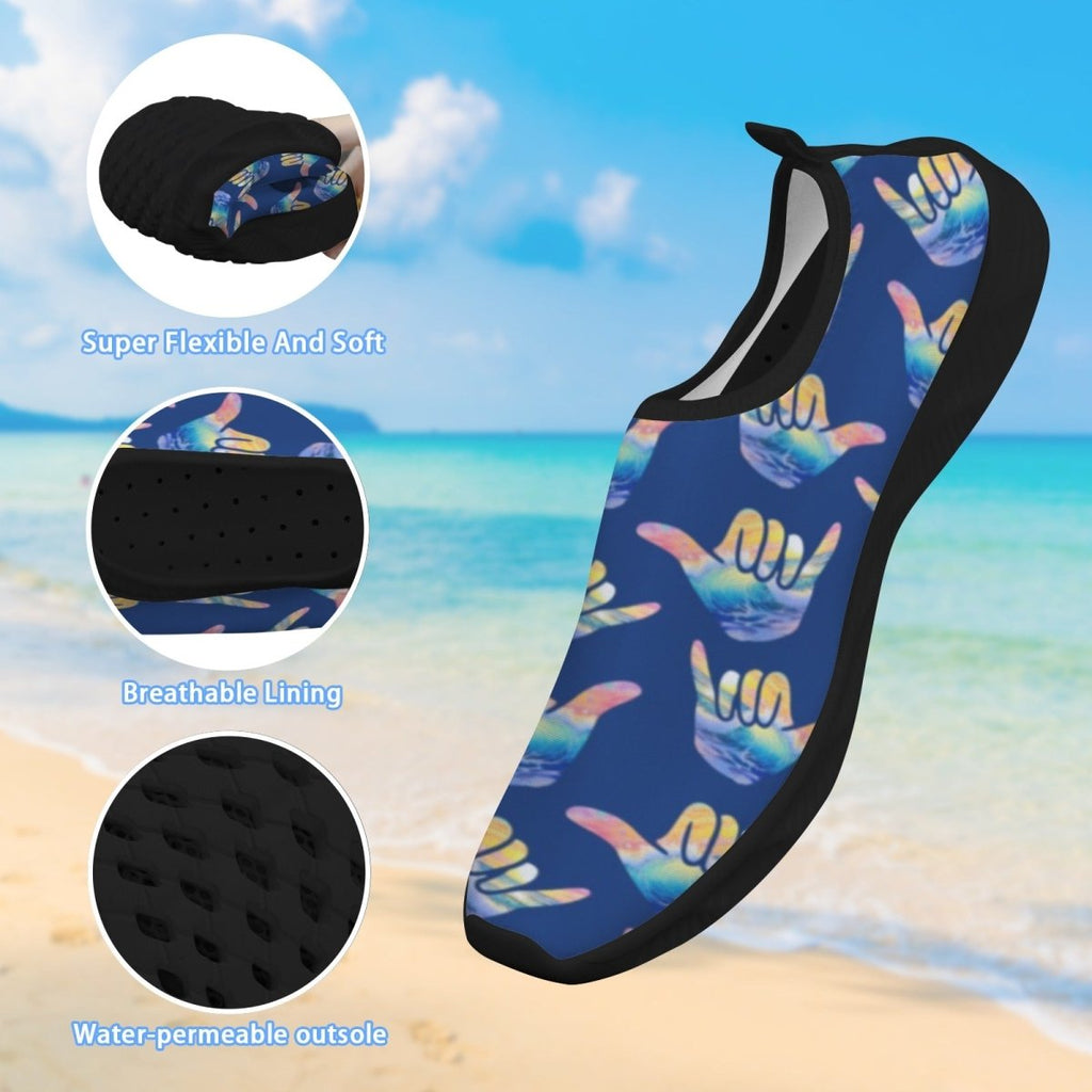 A single slip-on water shoe shown over a beach background, with three circular inset detail images on the left highlighting flexibility, breathable lining, and water-permeable outsole. The shoe has a dark blue base with a repeating multicolor Shaka graphic and black trim.