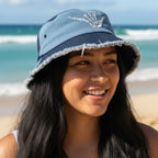 Pacific Islander surfer girl wearing a blue bucket hat with shaka sign bones on a Hawaiian Beach