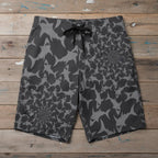 Infinite Shark Pattern Board Shorts on a rustic wood background