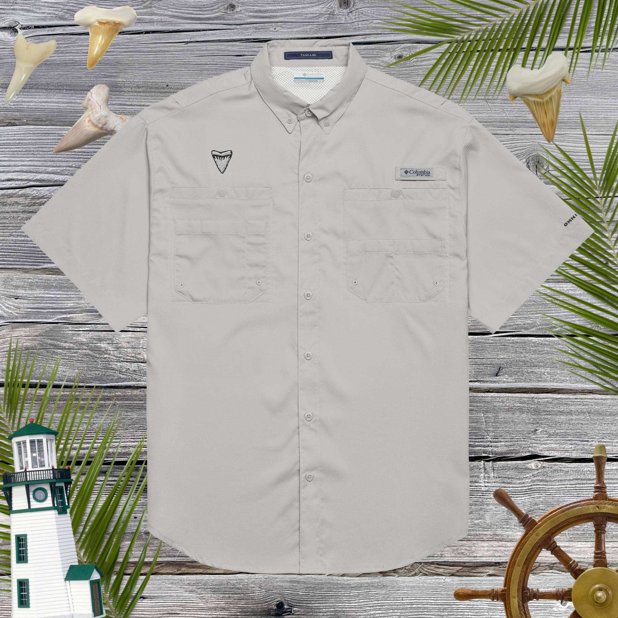 Light gray short-sleeve shirt with embroidered shark tooth on a wooden background with nautical elements.