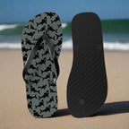 Flip-flop with shark pattern on a beach background