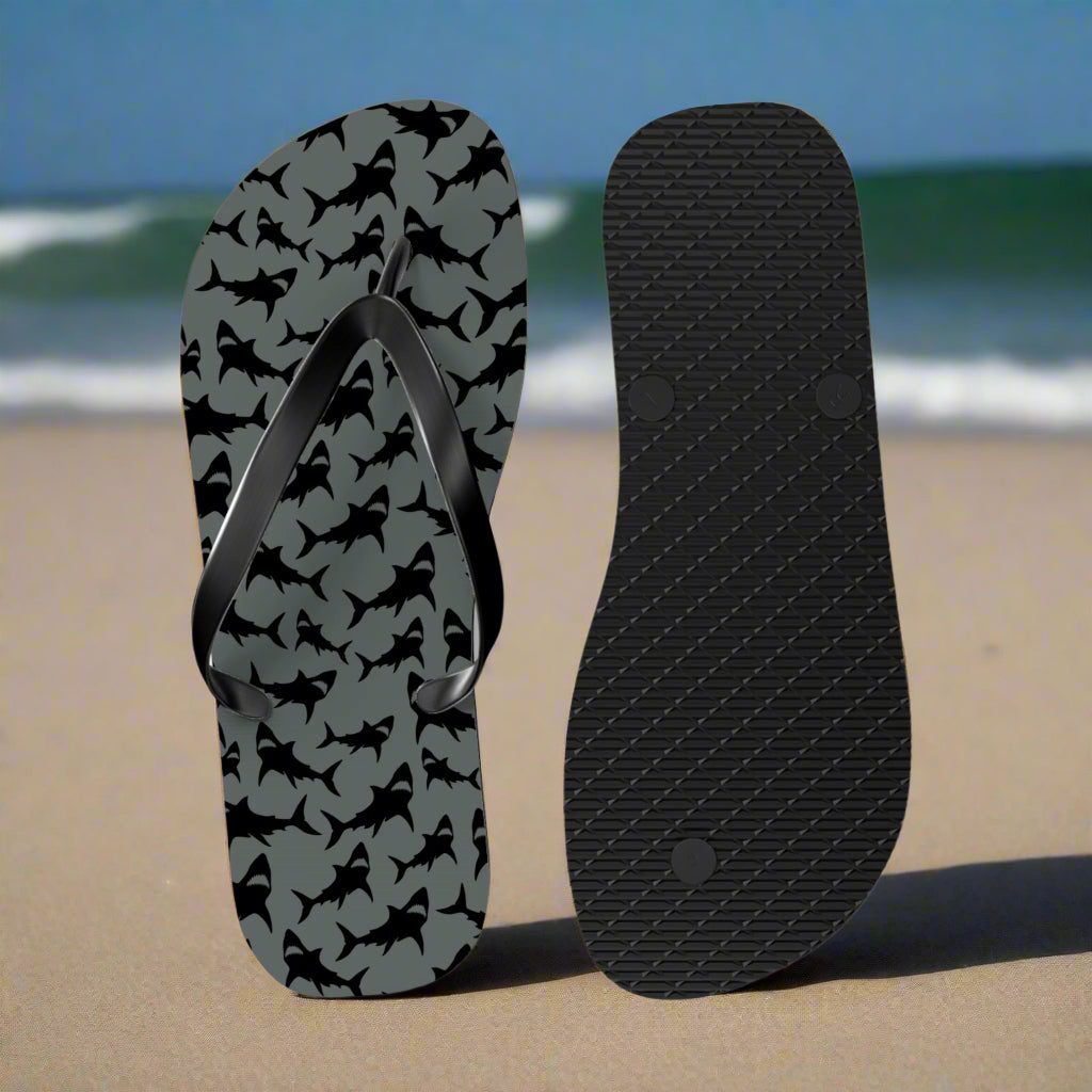 Flip-flop with shark pattern on a beach background