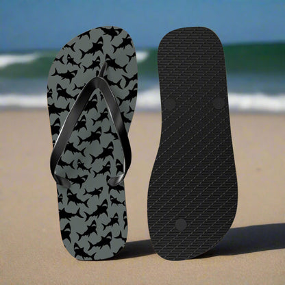 Flip-flop with shark pattern on a beach background