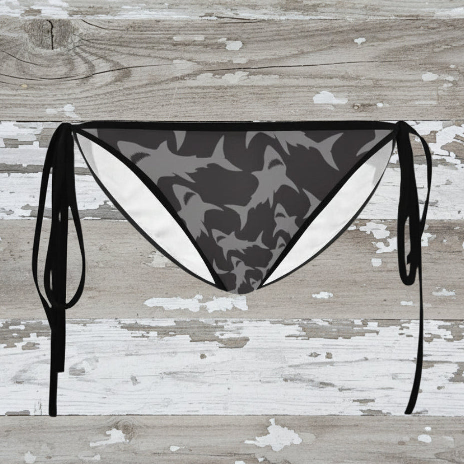 Black and gray shark pattern bikini bottom on a wooden surface