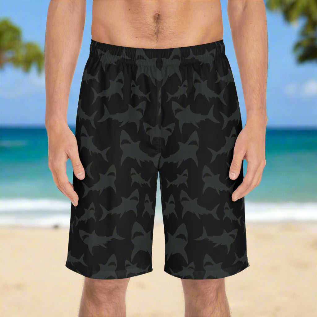 Men black shark pattern board shorts worn by surfer standing on the beach in Waikiki