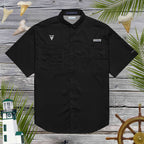 Black short-sleeve shark fishermans' shirt with shark tooth embroidery on a wooden background with nautical elements.