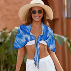 Beachwear model wearing her beach wrap as a shawl over her shoulders.