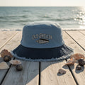 Blue bucket hat with frayed edge on a a beachside boardwalk