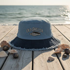Blue bucket hat with frayed edge on a a beachside boardwalk
