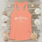 Coral tank top with 'Old Junonia Sheller's Club' text on a wooden surface with seashells.