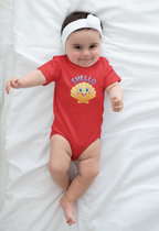 Baby wearing a red onesie with a shell design and 'Shello' text on a white blanket