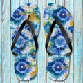 Pair of Shibori-patterned Tie-Dye Flip Flops on a wooden surface