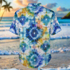 Short-sleeve Hawaiian shirt with shibori style tie-dye pattern print on a Maui beach background.