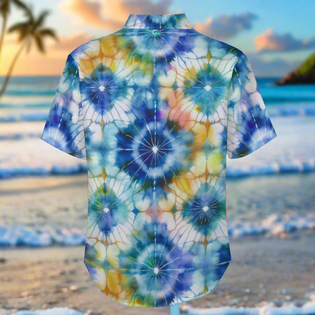 Short-sleeve Hawaiian shirt with shibori style tie-dye pattern print on a Maui beach background.