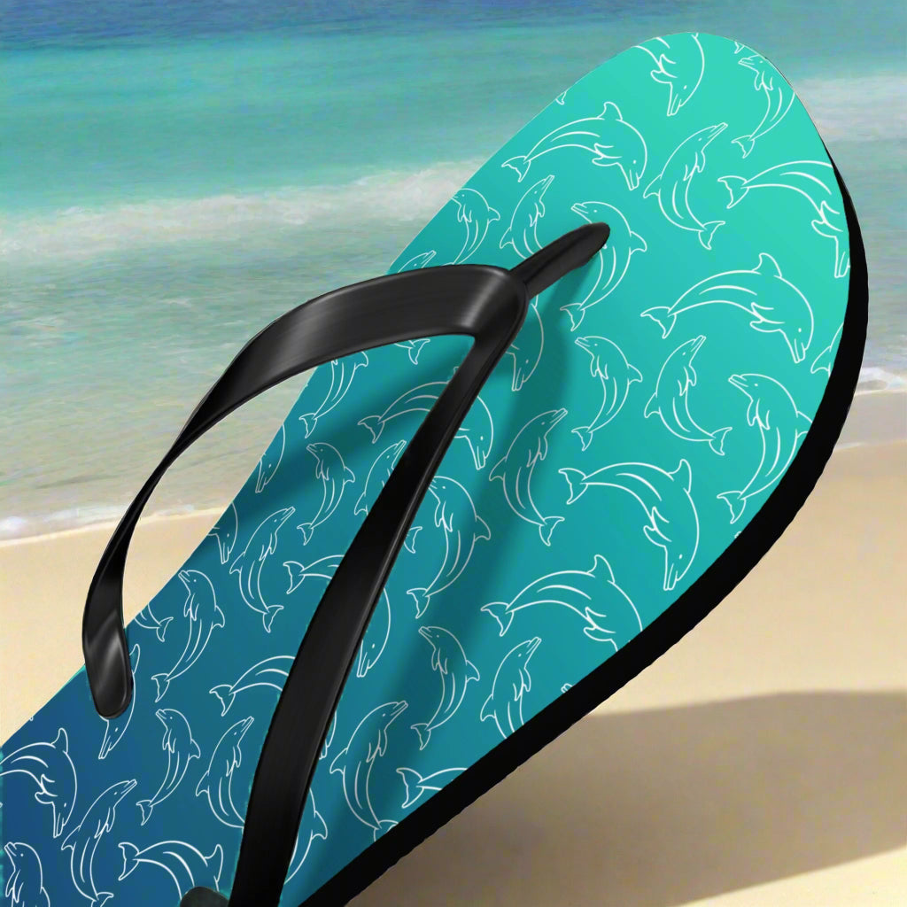 Flip-flop with dolphin pattern on a beach background