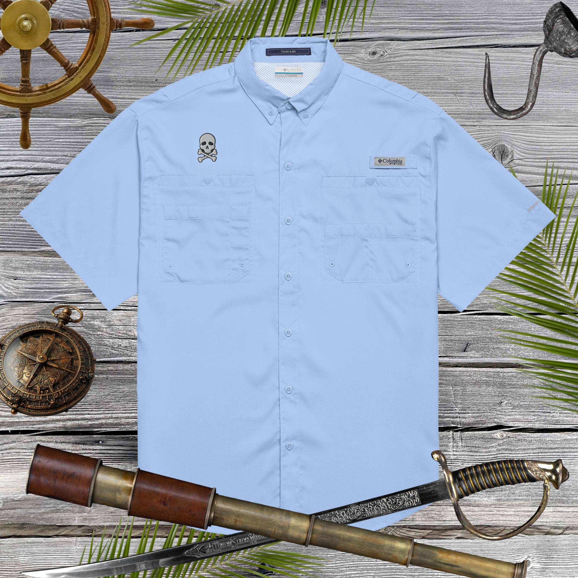 Light blue shirt with pirate skull embroidery on a wooden background with nautical items