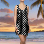 Black Skull and Crossbones Tank Top Dress on a salty swimsuit model standing in front of the ocean at sunset.