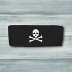 Black bandeau top with skull and crossbones design on a rustic wood background