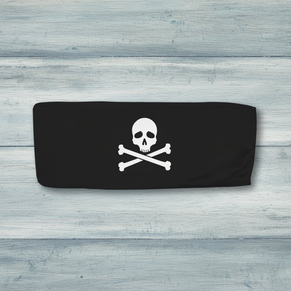 Black bandeau top with skull and crossbones design on a rustic wood background